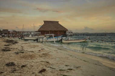 Isla Mujeres, Mexico 20 august 2022: Boats moored on the shore of Isla Mujeres beach at sunset.