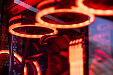 Milan, Italy 30 august 2022: Colorful bright led rgb pc fan air case cooler in white desktop computer chassis. gaming modding water cooling and technology concept background