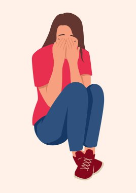 Depresyonda genç bir kadın yerde oturuyor.