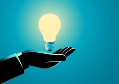 İş adamı elinde ampul, yenilik, fikir ve ilham kavramı tutuyor.