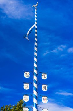 a traditional maypole with blue skies and sunshine. High quality photo