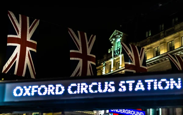 Oxford Circus Station sign in evening with flag of union jack. High quality photo