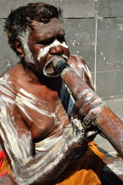 Aboriginal Man Playing Didgeridoo clipart