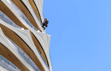 High rise building clean expert doing window cleaning job