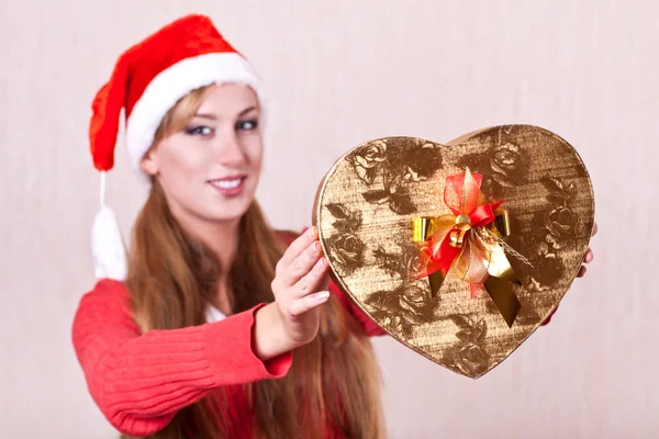 Young woman in Santa Claus hat with gift box — Stock Photo, Image