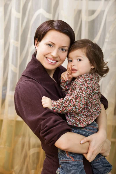 Happy mother holding child in arms — Stock Photo, Image