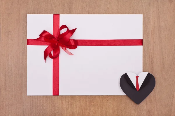 Card with red ribbon and black heart — Stock Photo, Image