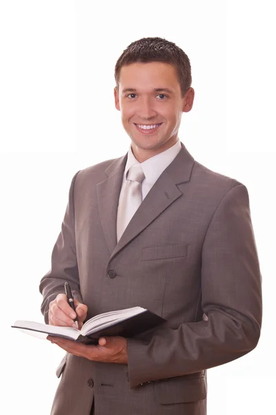 Positive businessman with notepad — Stock Photo, Image