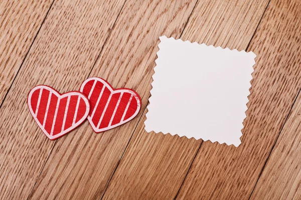 Two red hearts and blank paper — Stock Photo, Image