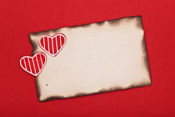 Two hearts and burnt paper — Stock Photo, Image