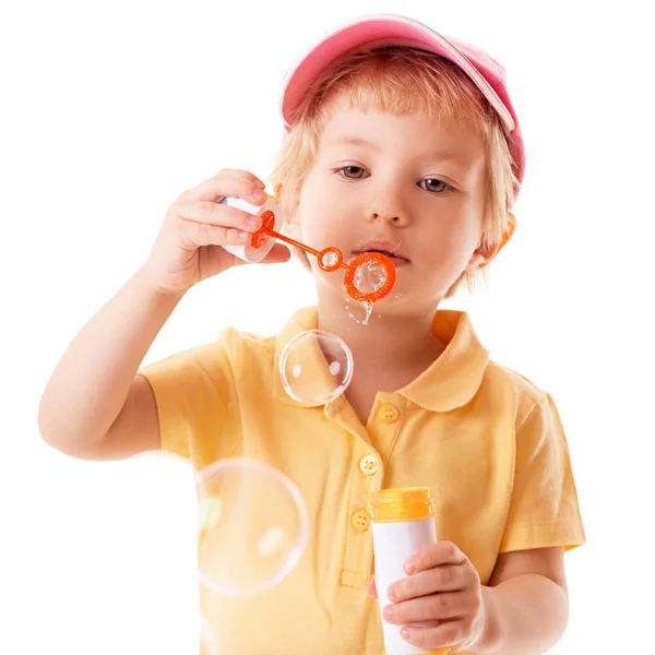 Little girl blows soap bubbles — Stok fotoğraf