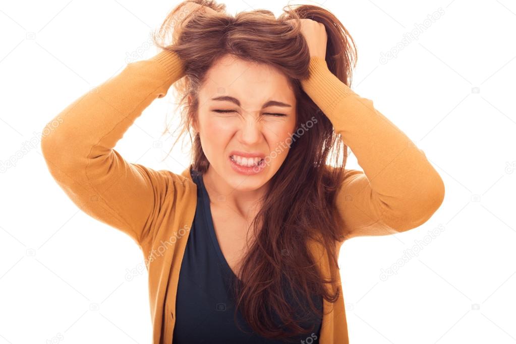 stressed woman holds hands hair
