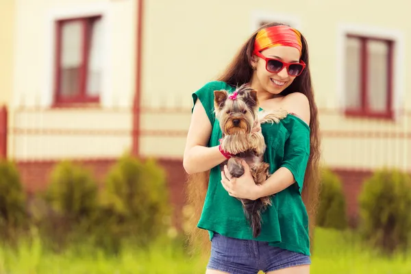 Smiling girl with dog yorkie terrier on hands — Stock Photo, Image