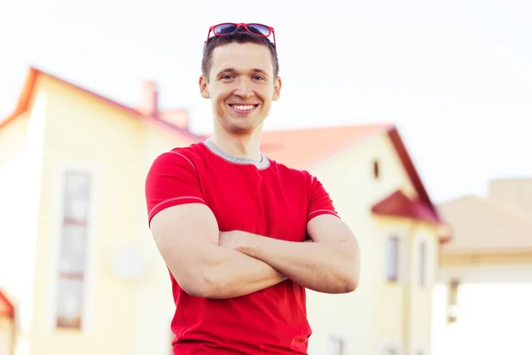 Positive man on background new house — Stock Photo, Image