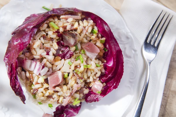 Brown rice with red radicchio and speck — Stock Photo, Image