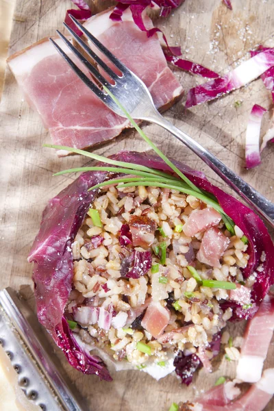 Brown rice with red radicchio and speck — Stock Photo, Image