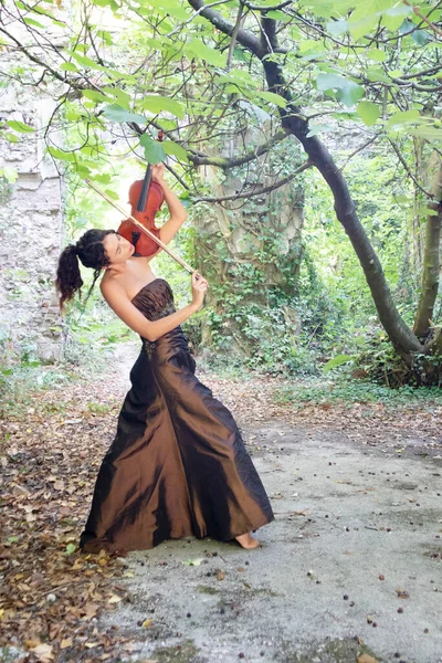 Photographic documentation of a beautiful girl playing the violin outdoors