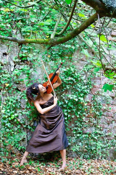 Photographic documentation of a beautiful girl playing the violin outdoors