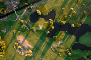 Aerial photographic documentation of a golf course taken at sunset 