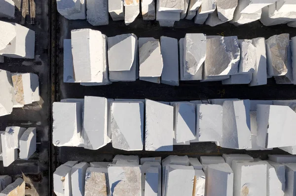 Aerial photographic documentation of a warehouse of white marble blocks ready for shipment