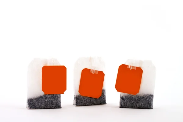 Three tea bags with tags — Stock Photo, Image