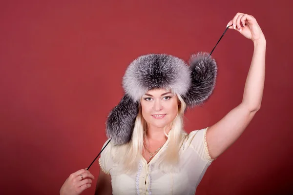 Blond girl in a fur hat — Stock Photo, Image