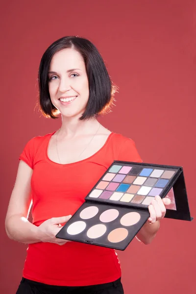 Schöne junge Frau mit anderem Make-up Stockbild