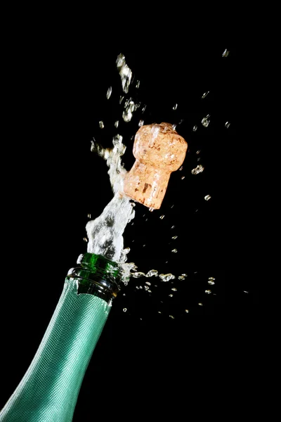 Celebration theme with splashing champagne — Stock Photo, Image