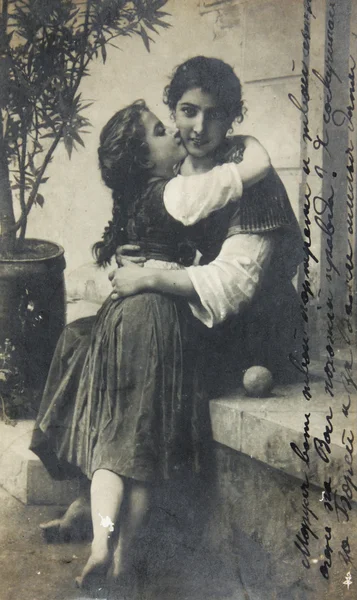 RUSSIA-CIRCA 1911: Antique postcard with two sisters,text saying "Marusia here is portrait of you and your sister,it looks like you,right ? I miss you" in Russian, circa 1911 — Stock Photo, Image