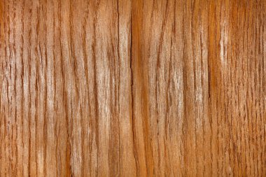 Fragment of texture and background of brown oak veneer with bulges and cracks. Closeup.