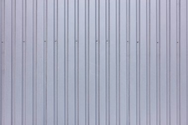 Metal vidalarla sabitlenmiş gri profilli bir çitin arkaplan ve dokusu.