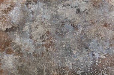 An abstract pattern in grey, beige and brown tones interspersed with dirty spots on the canvas.