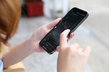 Akıllı telefon ile kadın eli Kafe İş Konseptinde hisse senedi ticareti