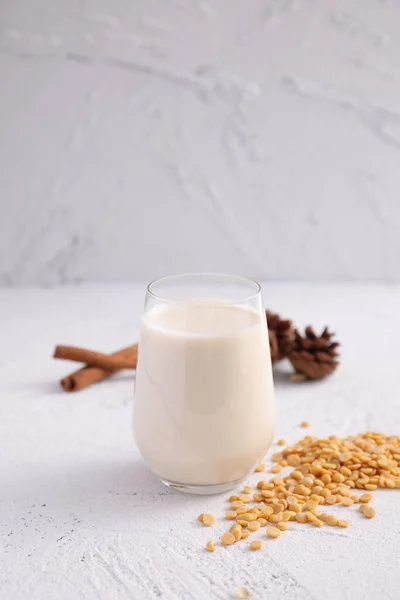 Soy milk in glass and soy bean isolated in white background