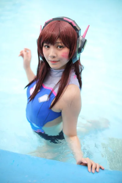 Portrait of Japan anime cosplay girl with swim suit at swimming pool