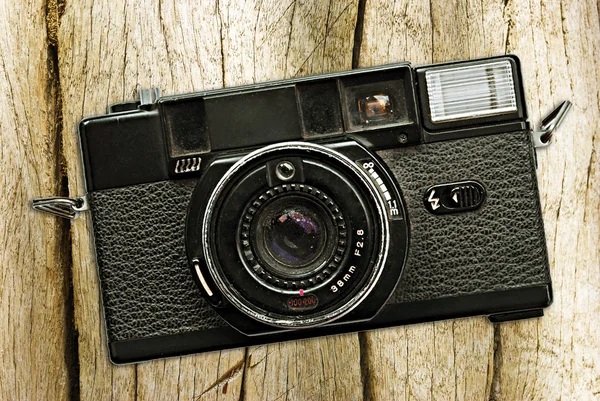 Retro fotoaparát na dřevěném stole — Stock fotografie