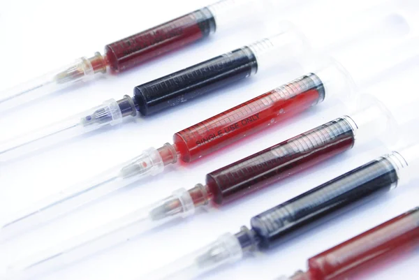Medical syringes with colorful liquid isolated over white — Stock Photo, Image
