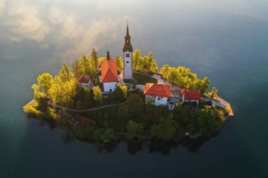 Gölü güzel bir bahar sabahı, gün doğumunda sisli ve alçak bulutlu