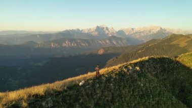 Julian Alpleri 'nin dağlarındaki tepenin zirvesinde bir yürüyüşçü..