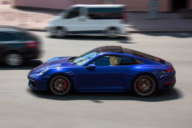 Kiev, Ukraine - June 19, 2021: Blue supercar Porsche 911 Carrera S in the city. Porsche in motion