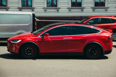 Kiev, Ukraine - June 19, 2021: Tesla Model X red electric car on the road