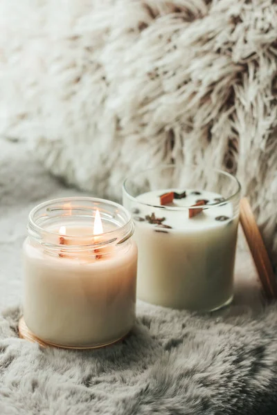 Scented candles in the interior. Interior details in milk colors. Candles in a glass