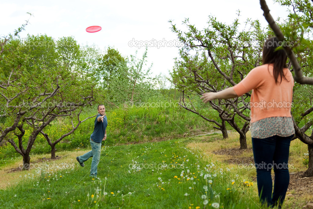 Couple Playing Frisbee Together