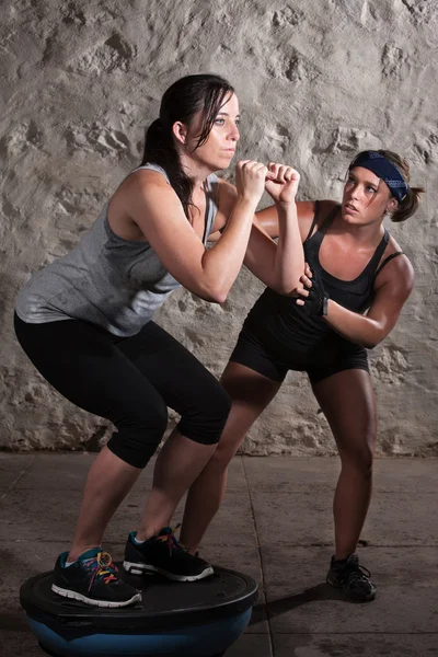 Two Women in Boot Camp Balance Training Stock Image