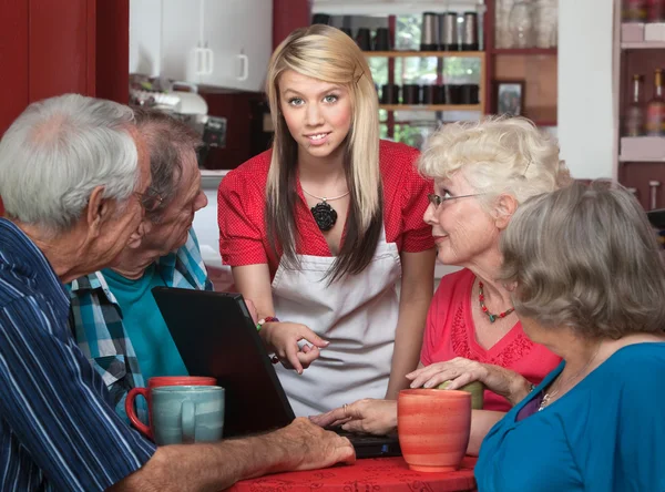 Seniors with Laptop and Helpful Waitress — Stock Photo, Image