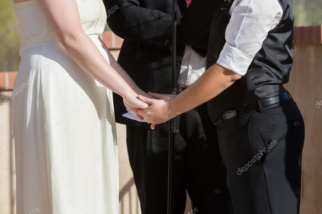 Women Holding Hands in Wedding Ceremony