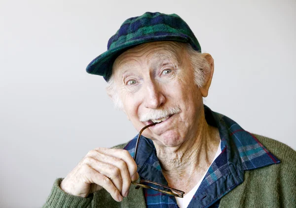 Thoughtful Senior Man in a Hat and Glasses — Stock Photo, Image