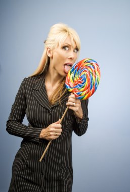 Woman licking a lollipop clipart