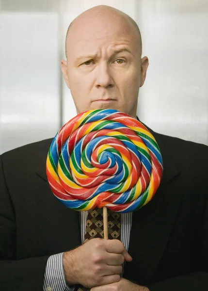 Affärsman med stora lollipop — Stockfoto