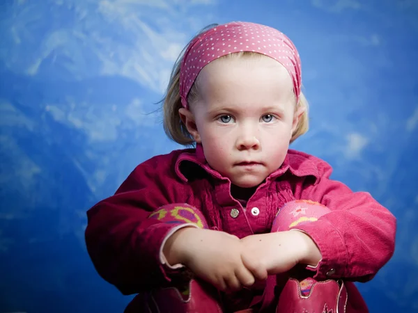 Little girl in front of blue — Stock Photo, Image